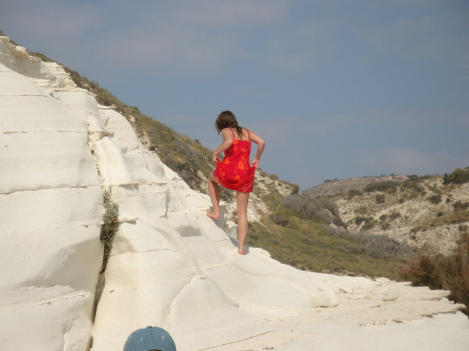 Beautiful girls posing on a white rock beach