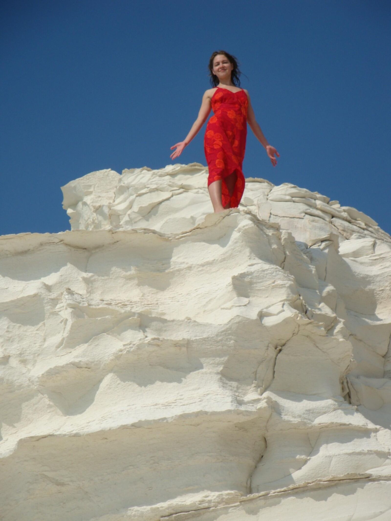 Beautiful girls posing on a white rock beach