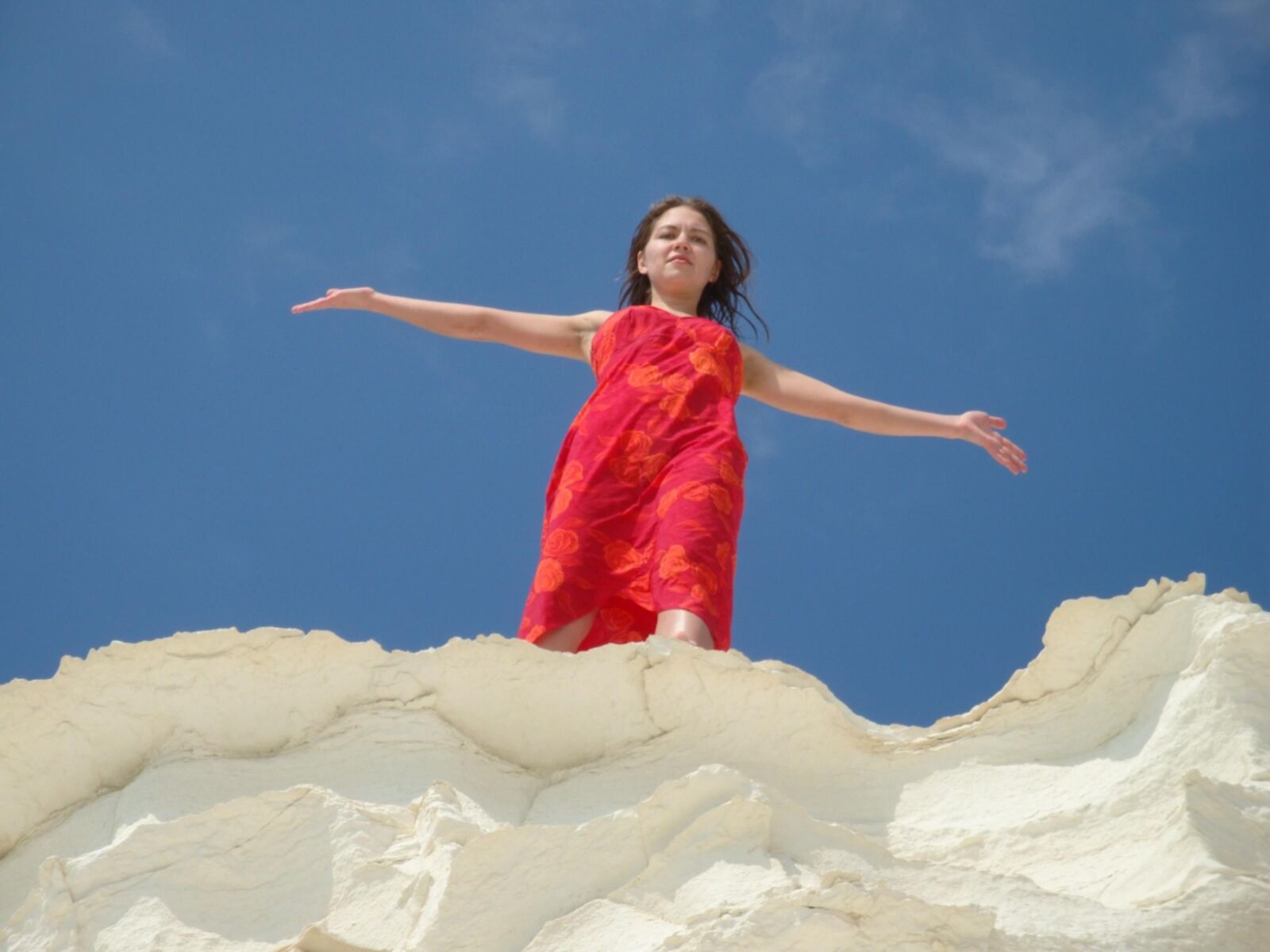 Beautiful girls posing on a white rock beach