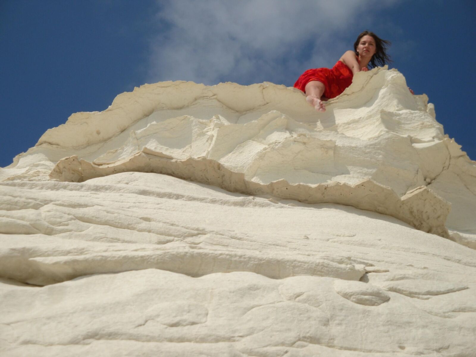 Beautiful girls posing on a white rock beach