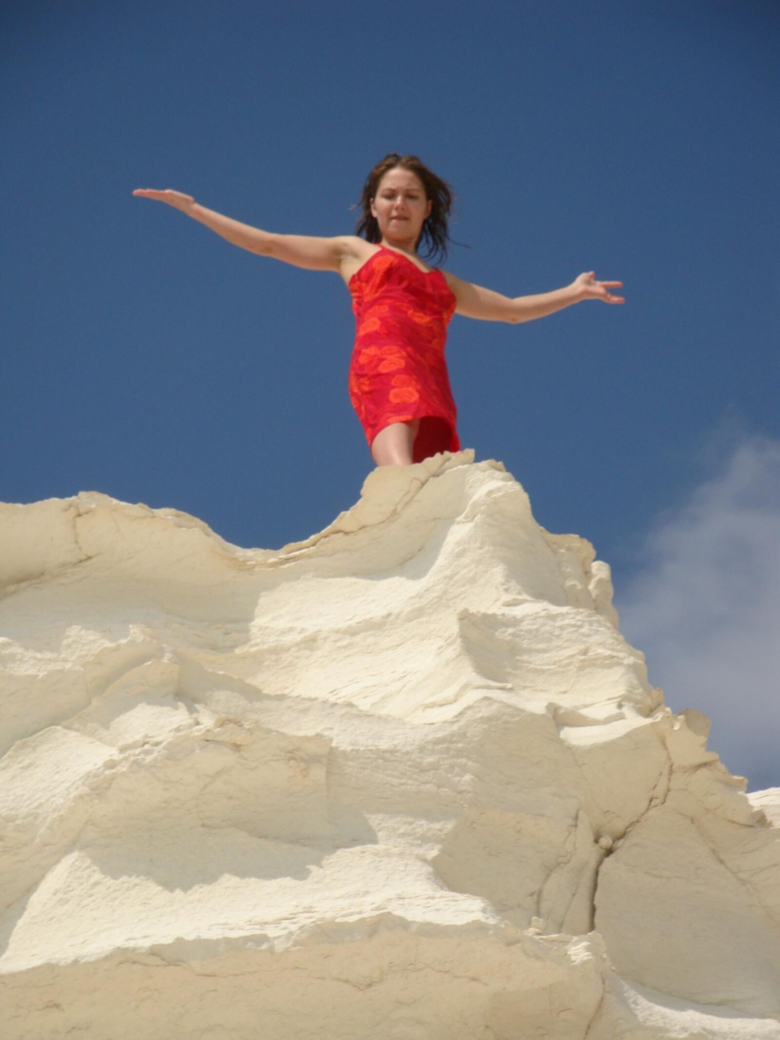 Beautiful girls posing on a white rock beach