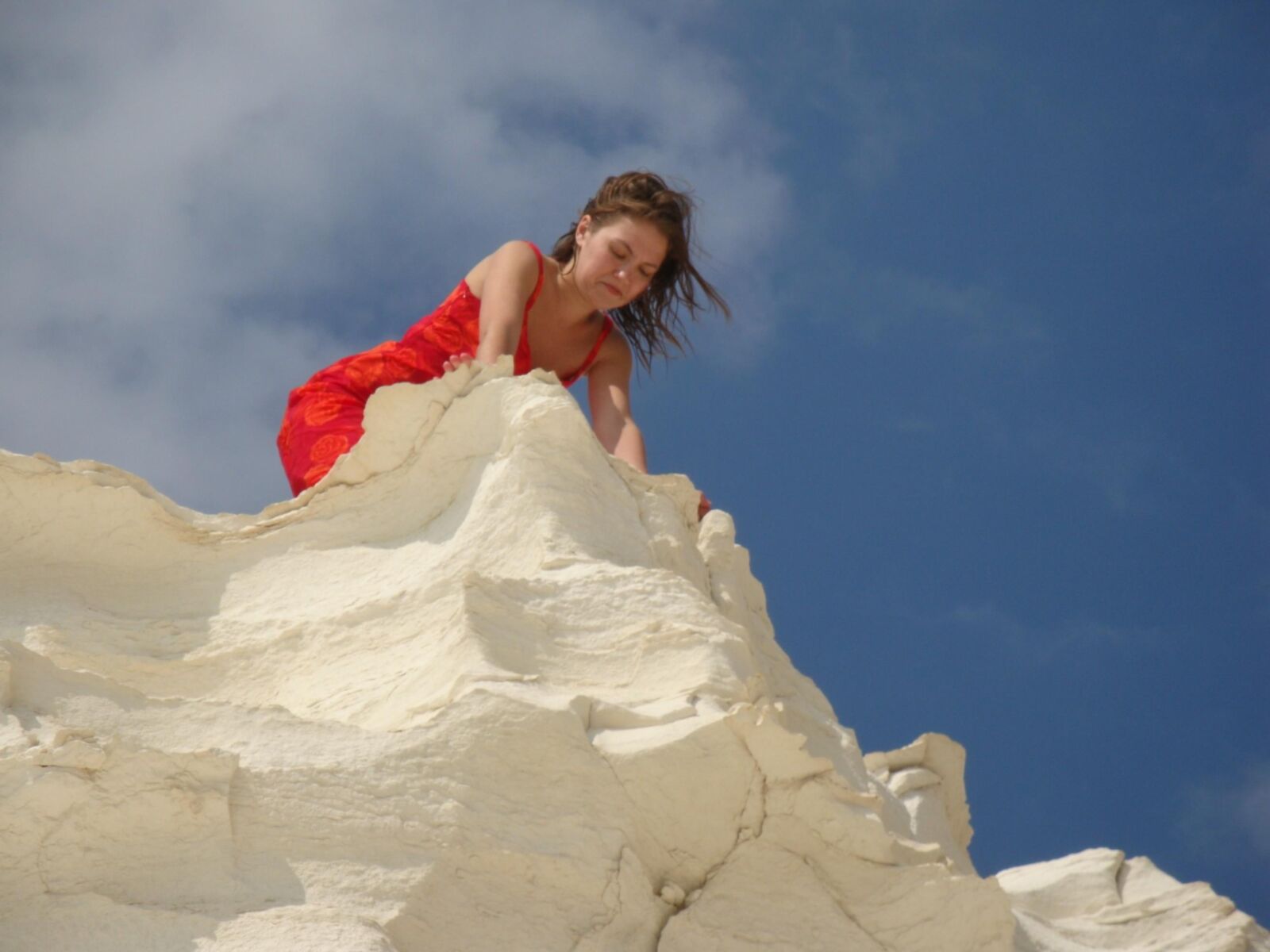 Beautiful girls posing on a white rock beach