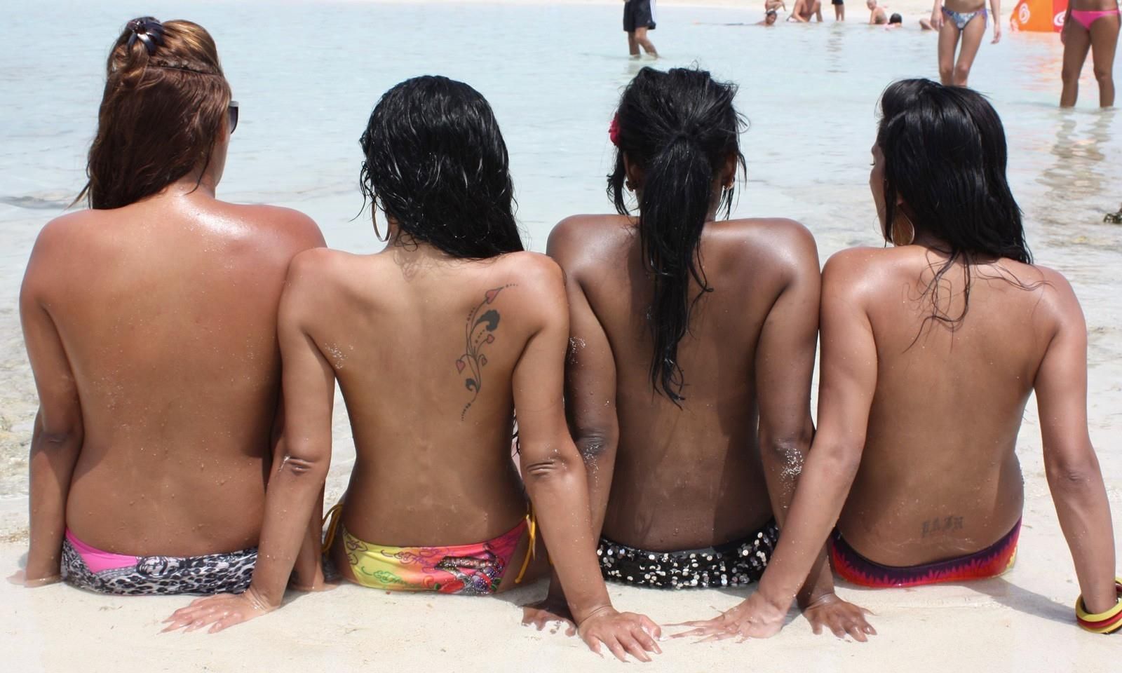 Four teasing teens at the beach