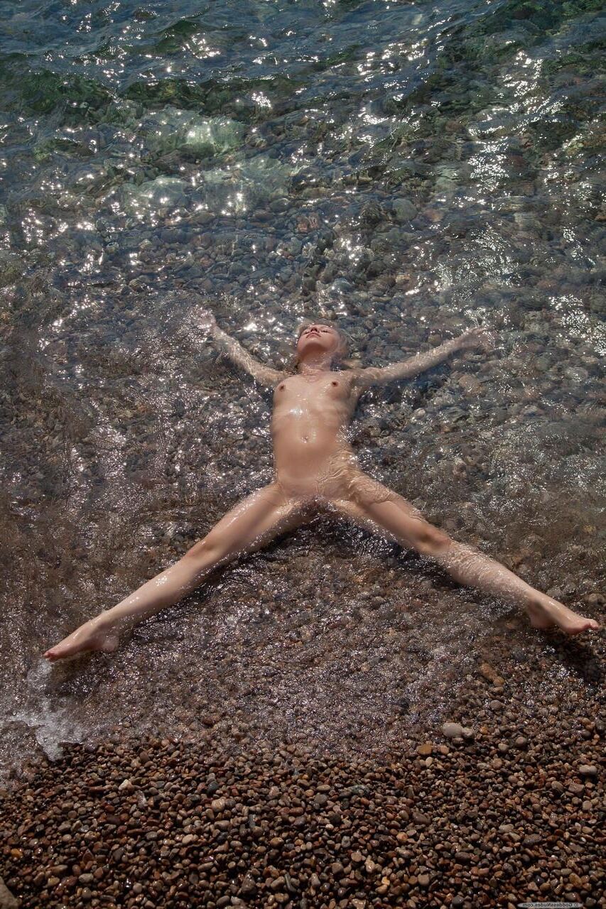 Blonde cute teen nude at the beach