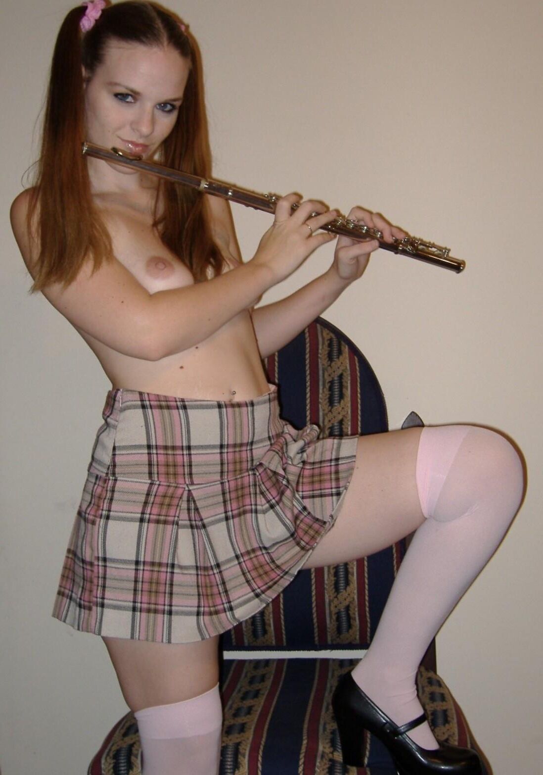 Innocent schoolgirl does naughty things with her flute